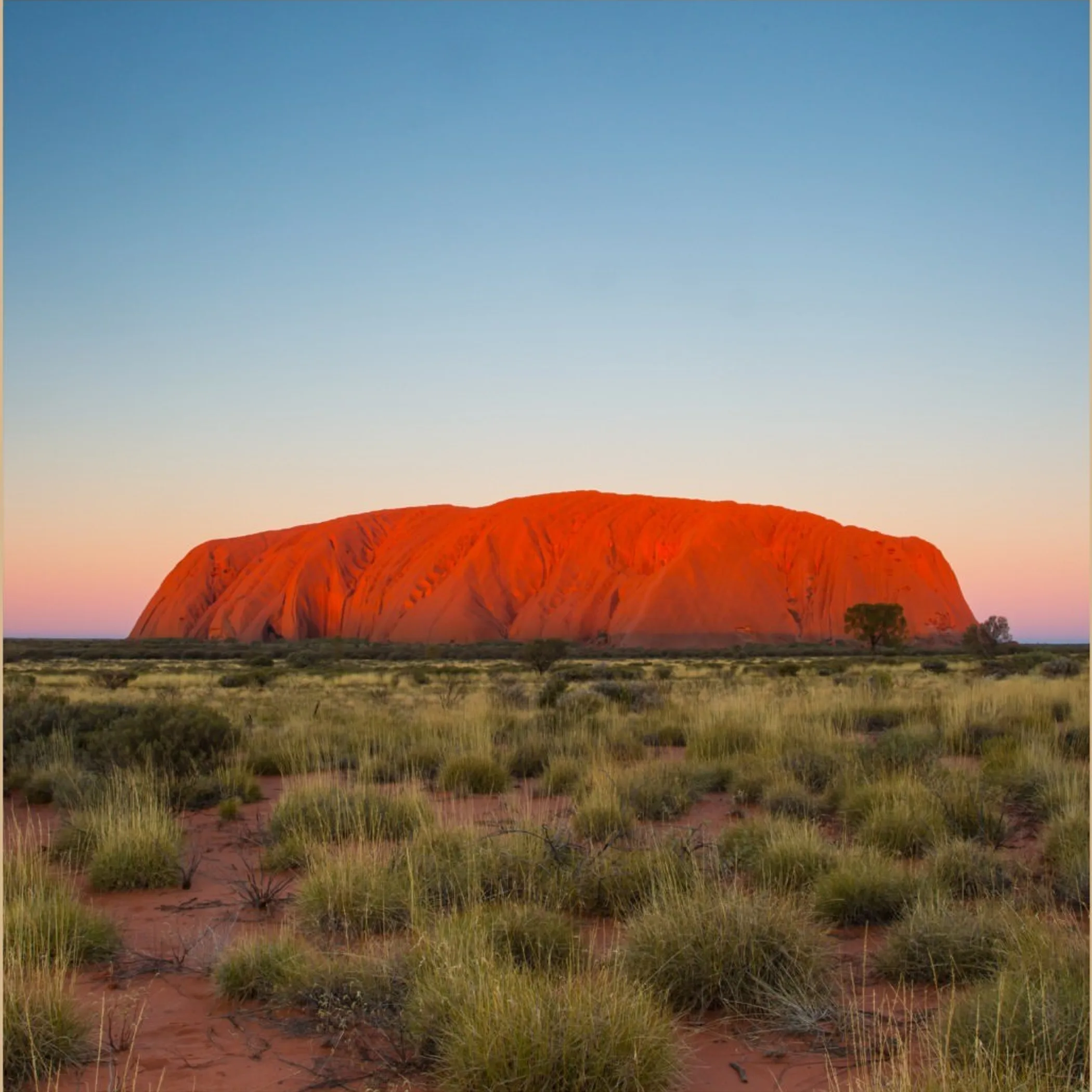 uluru rock formation under clear sky